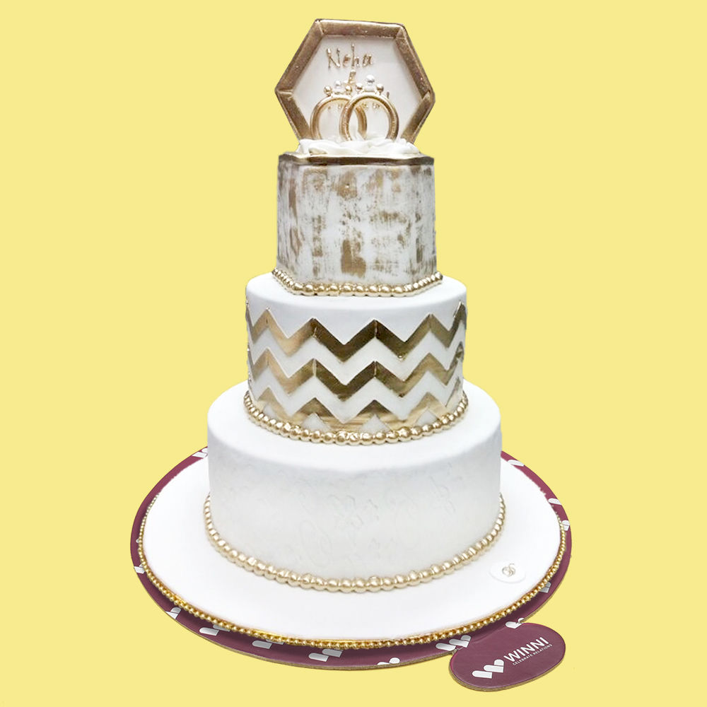 White wedding cake with gold rings. Funny wedding cake from mastic with a  cup of milk and cookies. white wedding cake with | CanStock