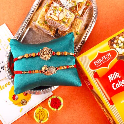 Buy Ganesha & Peacock Rakhis with Milk Cake