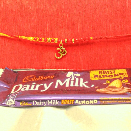 Buy Om Blessed Rakhi with Dairy Milk