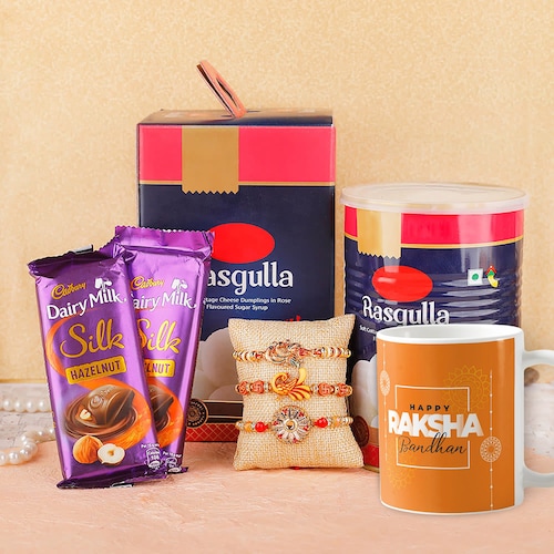 Buy Set of Three Rakhi With Mug Rasgulla & Silk Chocolates