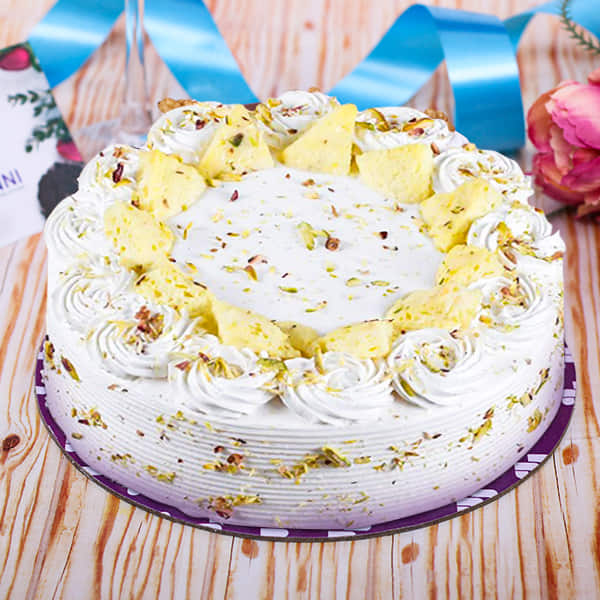 Send Online 1kg heart shape rasmalai cake and 10 roses bouquet Order  Delivery | flowercakengifts