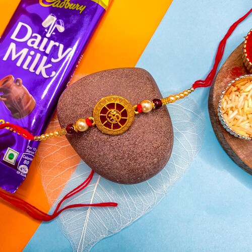 Buy Gold Pearl Om Rakhi With Dairy Milk Chocolate Bar