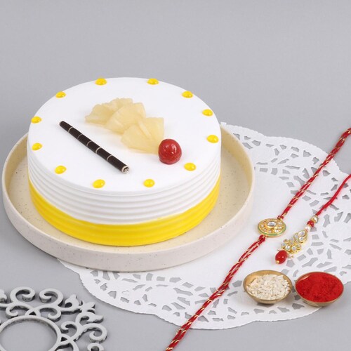 Buy Kundan Couple Rakhi With Pineapple Cake