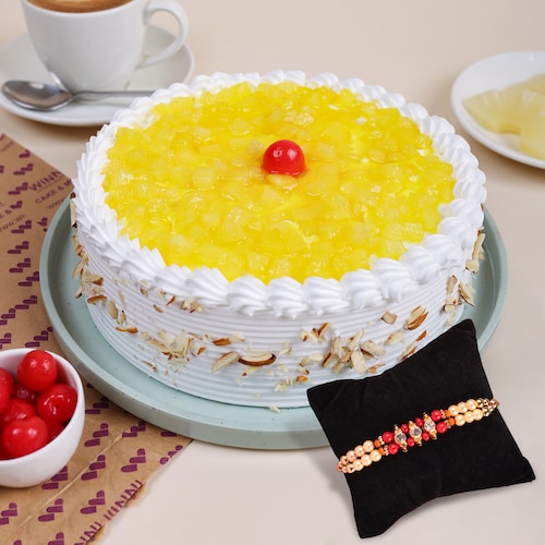Buy Fresh Pineapple Cream Cake And Two Layer Beads Rakhi
