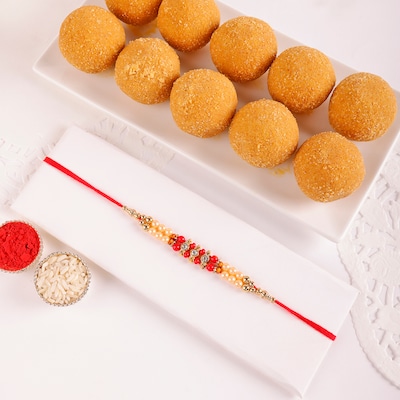 Elegant Pearl And Beads Rakhi With Besan Laddoo