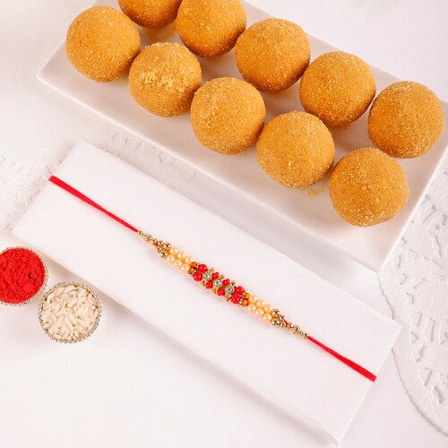 Buy Elegant Pearl And Beads Rakhi With Besan Laddoo