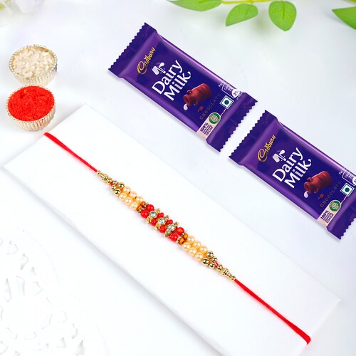 Buy Two Layer Pearl Rakhi With Cadbury Dairy Milk Chocolate